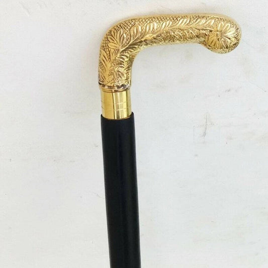 Decorative walking cane with gold handle on a white background
