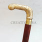 Decorative walking cane with gold handle on a light gray background, branded 'Creativeera'.